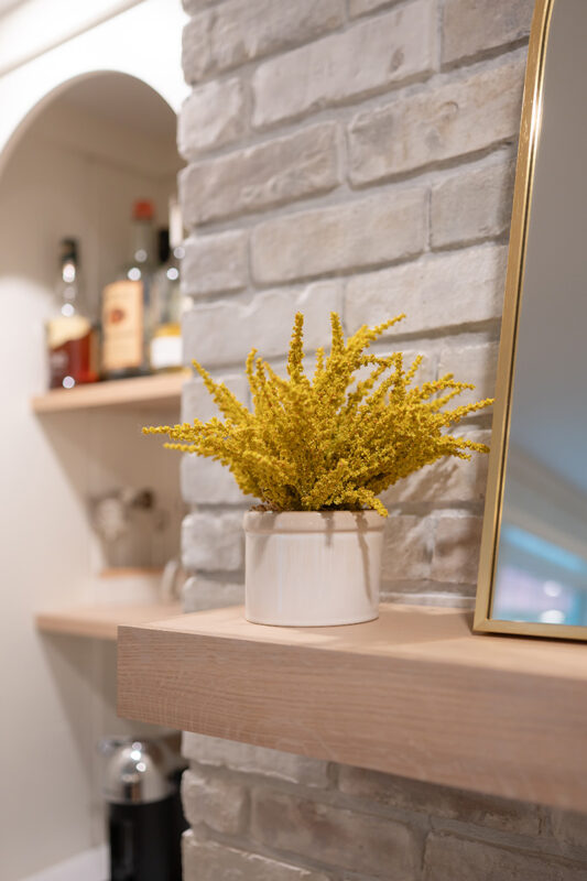 Kitchen with White perimeter cabinets and Quartersawn White Oak island cabinets stained in light brown Pampas finish.