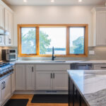 White kitchen with dark stained island and accents.