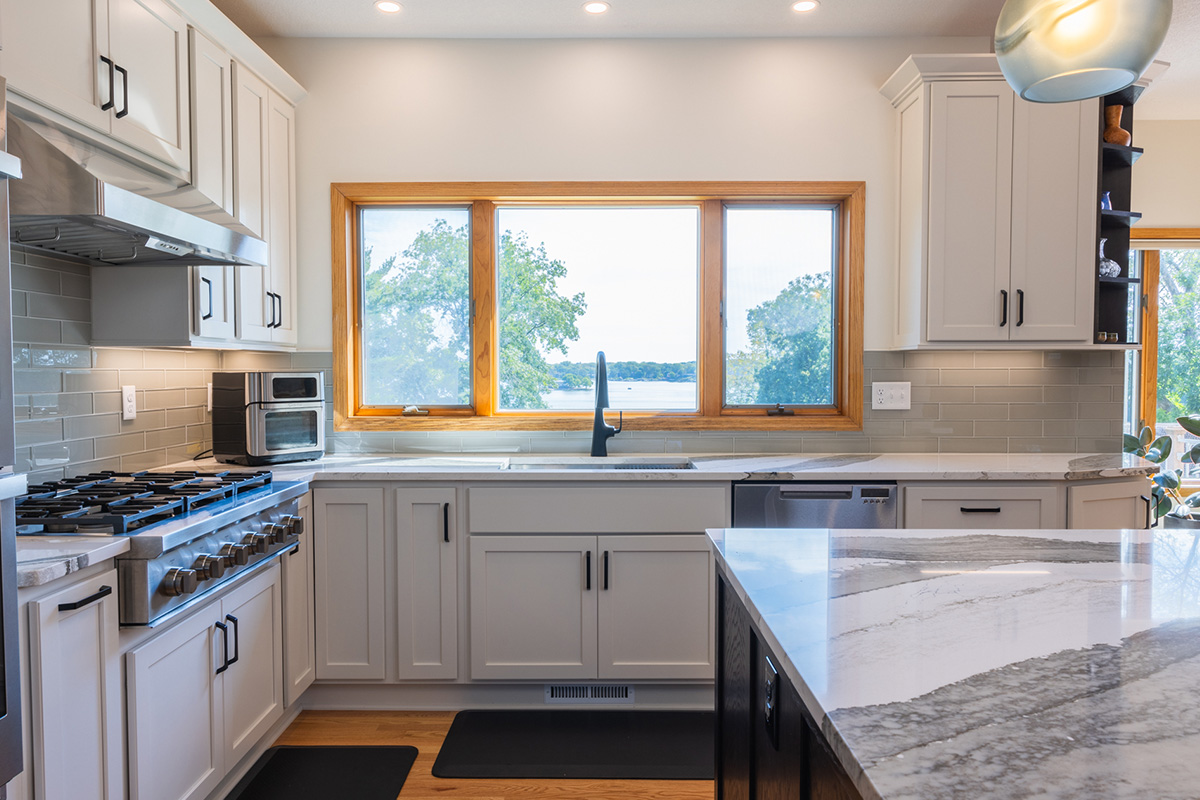 White kitchen with dark stained island and accents.