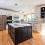 White kitchen with dark stained island and accents.