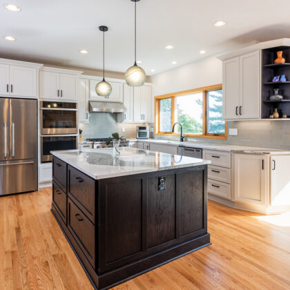 White kitchen with dark stained island and accents.