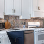 White and blue kitchen cabinets. View of the sink.