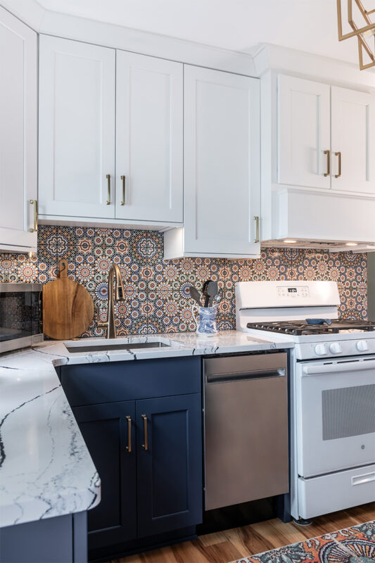 White and blue kitchen cabinets. View of the sink.