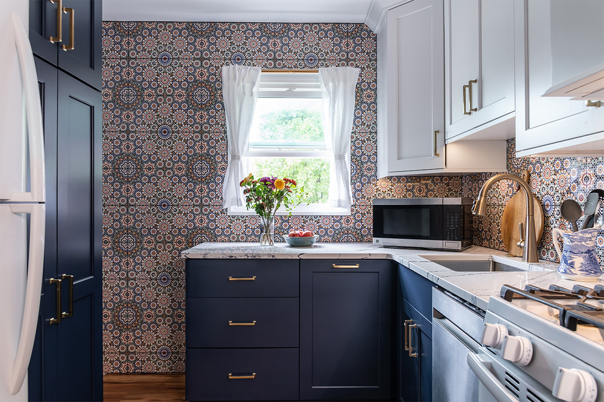 White and blue kitchen cabinets. View out a window.