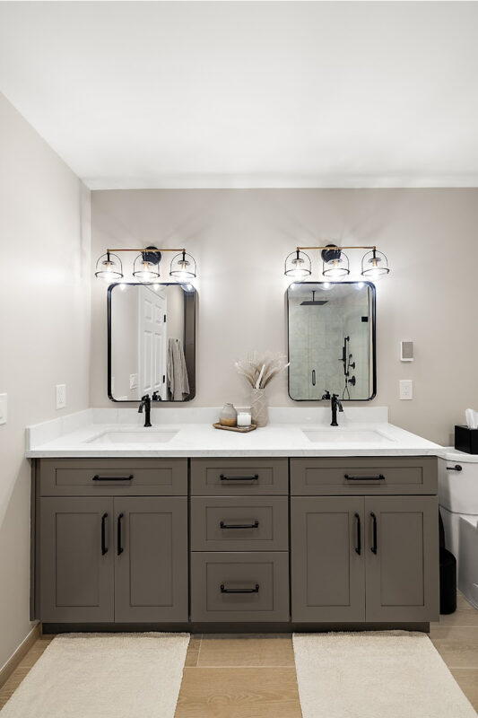 Gray bathroom vanity with 2 sinks and mirrors