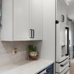 White kitchen cabinets and fridge