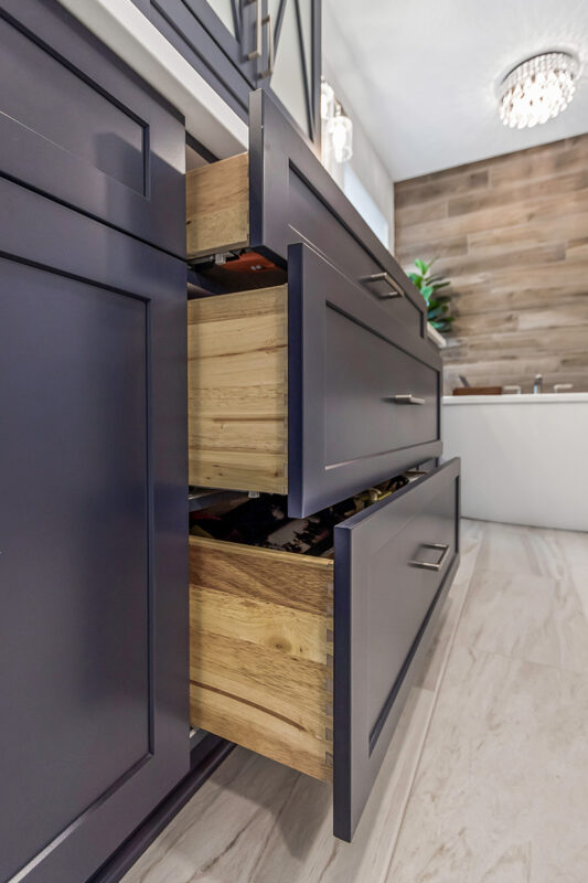 Blue bathroom vanity with drawers open