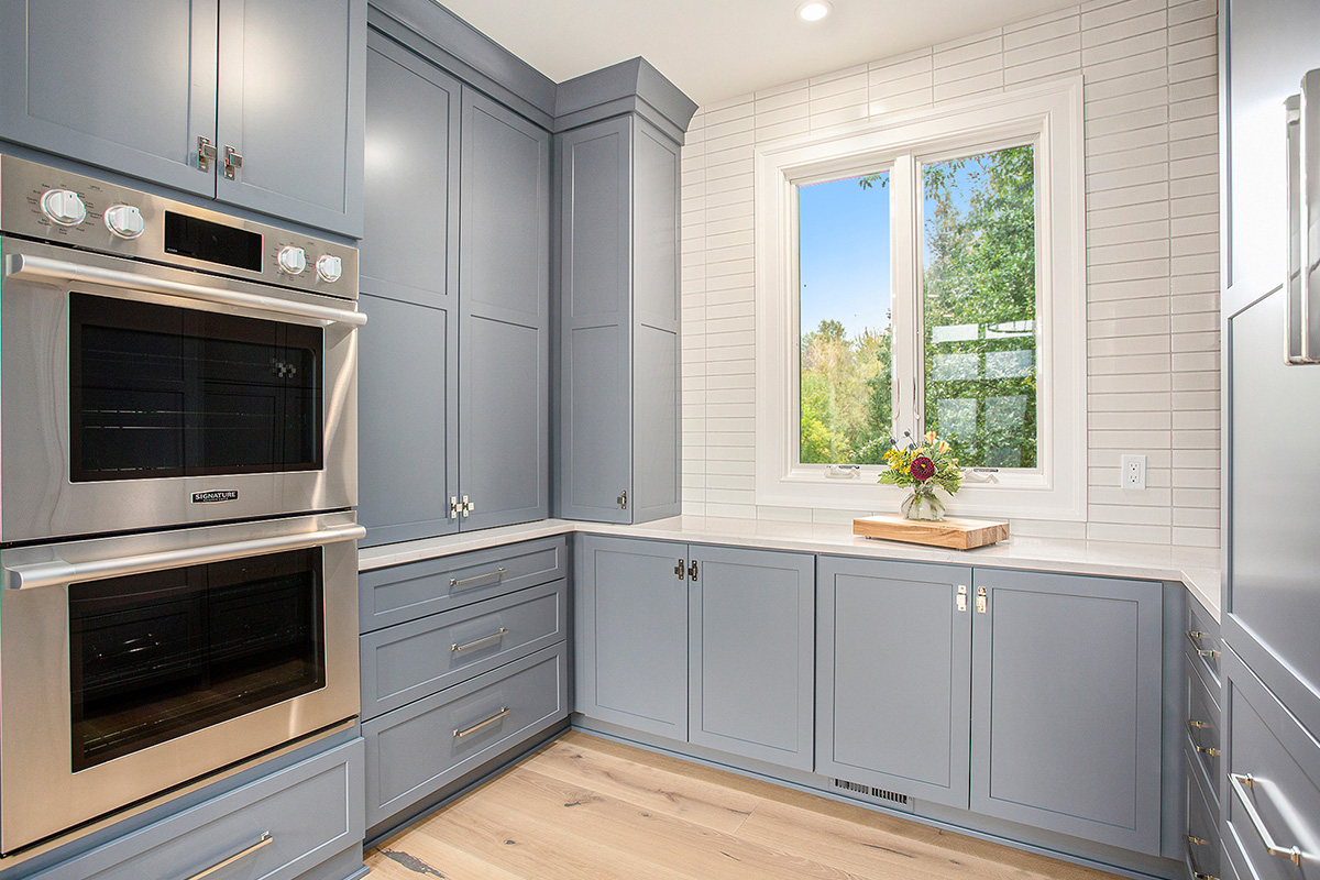 Painted pantry cabinets with double oven.