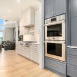 Blue pantry looking into the white kitchen cabinets