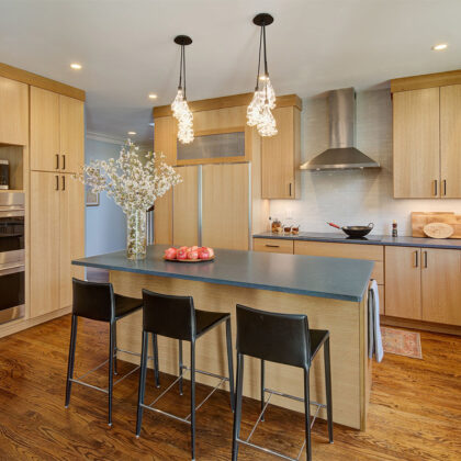 Light brown stained kitchen with island seating.