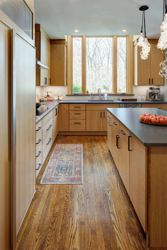 Light brown stained kitchen with island seating.
