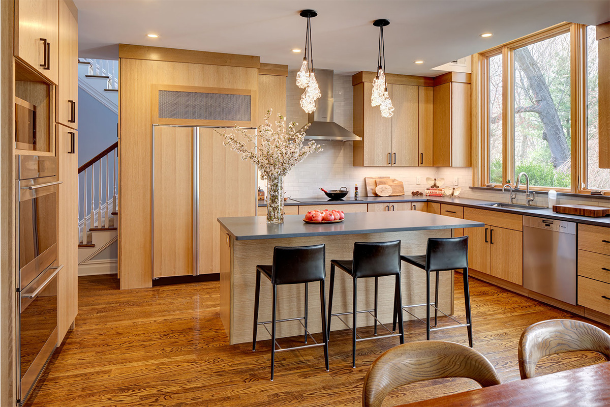 Light brown stained kitchen with island seating.