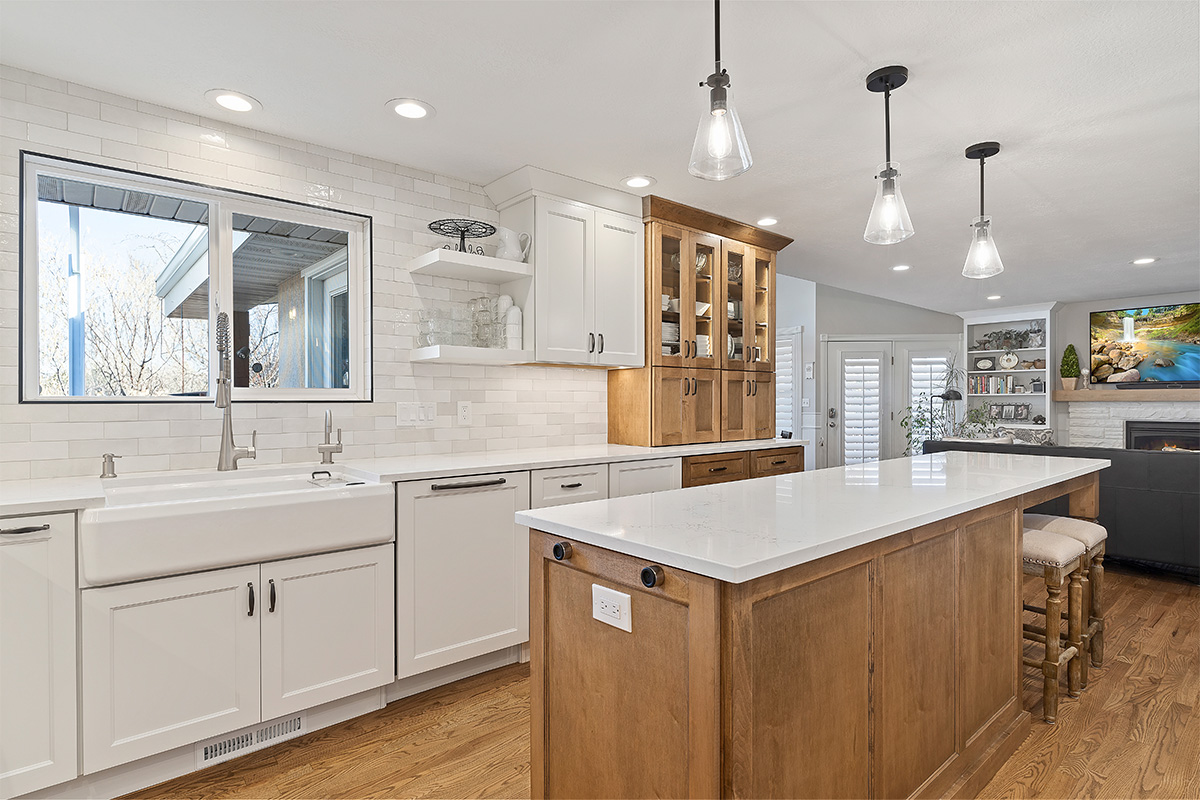 White and Cashew stained kitchen cabinets with long island with seating
