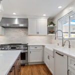 White and Cashew stained kitchen cabinets with long island with seating