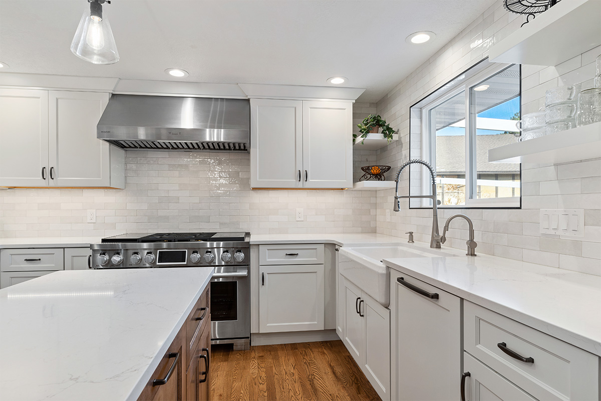 White and Cashew stained kitchen cabinets with long island with seating