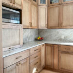 Cashew-stained kitchen perimeter cabinets.