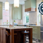 Painted kitchen perimeter cabinerts with walnut island.