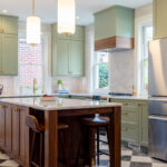 Painted kitchen perimeter cabinerts with walnut island.