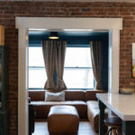 Living room view from the kitchen through an open walkway.