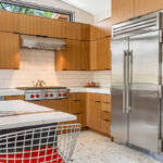 Kitchen with natural cherry perimeter cabinets and dark stained island cabinets.