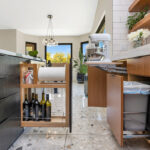 Kitchen with natural cherry perimeter cabinets and dark stained island cabinets.