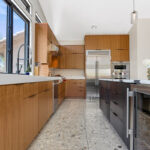 Kitchen with natural cherry perimeter cabinets and dark stained island cabinets.