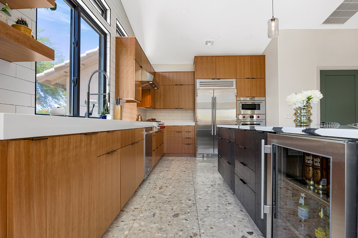 Kitchen with natural cherry perimeter cabinets and dark stained island cabinets.