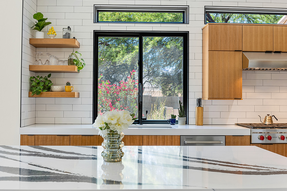 Kitchen with natural cherry perimeter cabinets.
