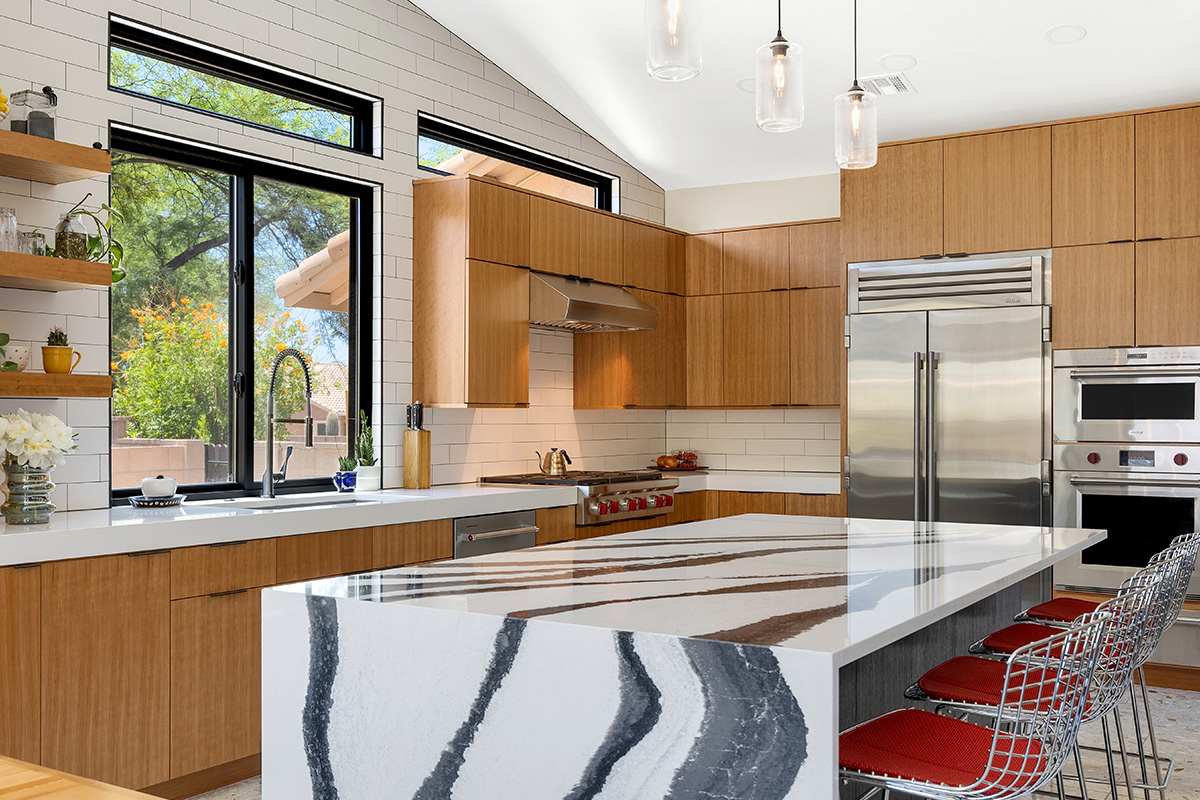 Kitchen with natural cherry perimeter cabinets and dark stained island cabinets.