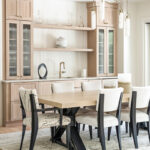 Light stained dining room serving station with table and chairs.