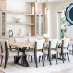 Light stained dining room serving station with table and chairs.