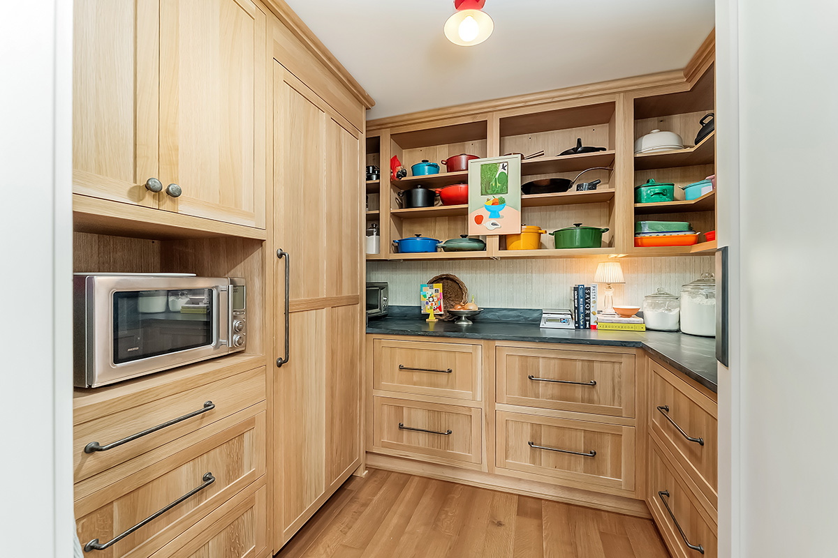 Pantry with light brown stained cabinets