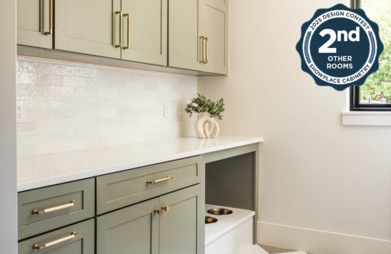 Light green mudroom cabinets with dog dish area under the counter.
