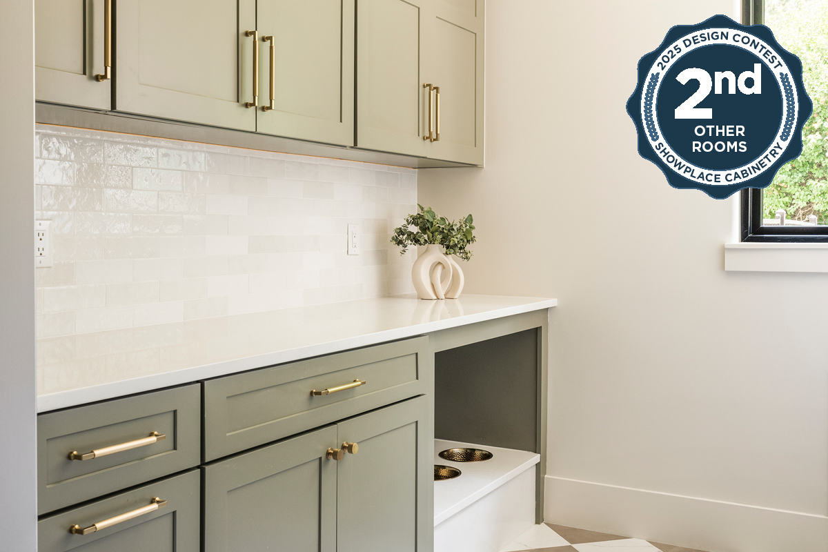 Light green mudroom cabinets with dog dish area under the counter.