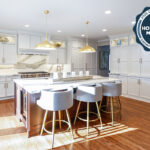 White kitchen perimeter cabinets with brown stained island and marble backsplash.