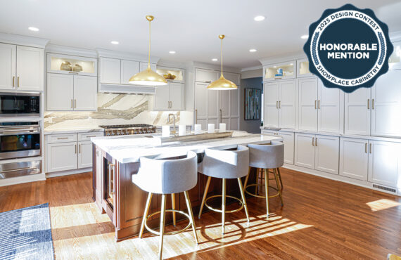 White kitchen perimeter cabinets with brown stained island and marble backsplash.