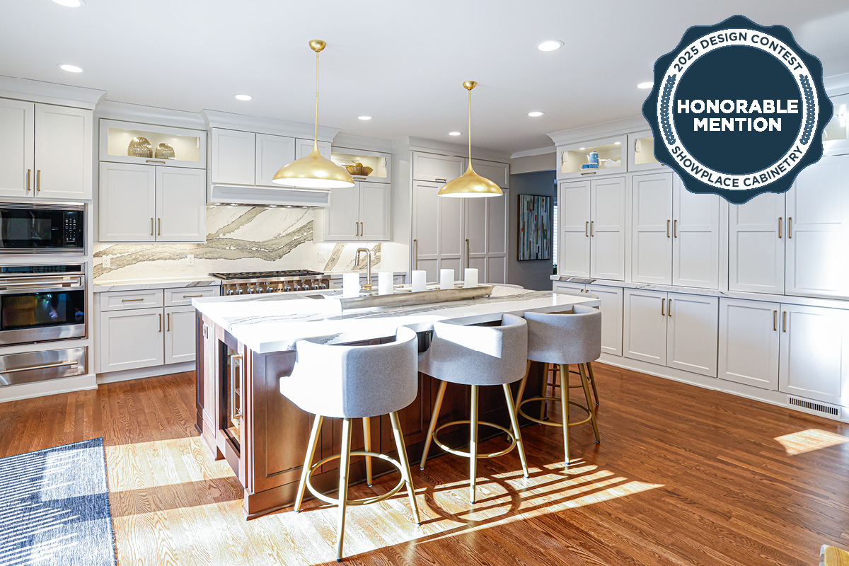 White kitchen perimeter cabinets with brown stained island and marble backsplash.
