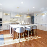 White kitchen perimeter cabinets with brown stained island and marble backsplash.