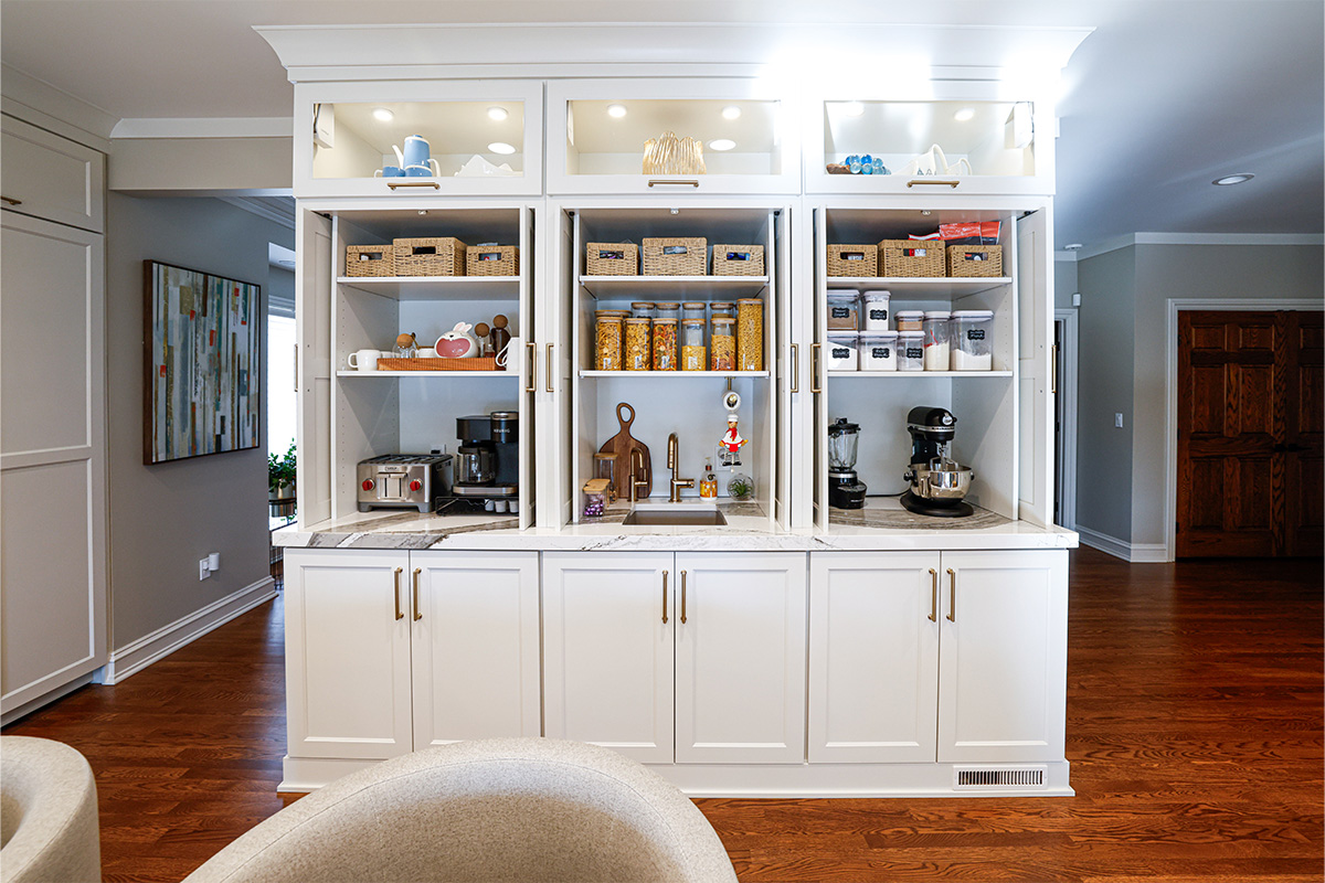 Open pocket door cabinets showing appliances and items inside.