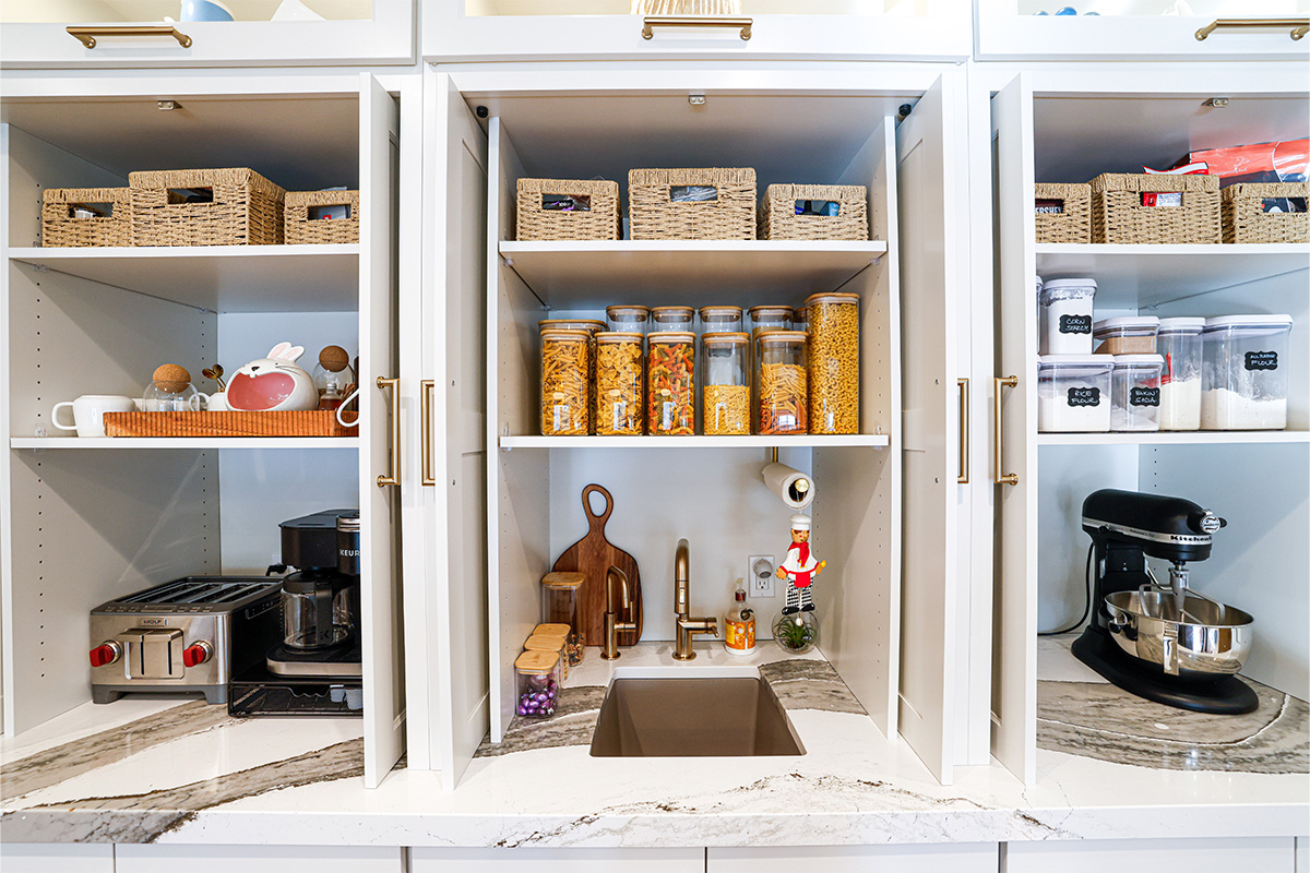 Open pocket doors showing appliances and items inside.
