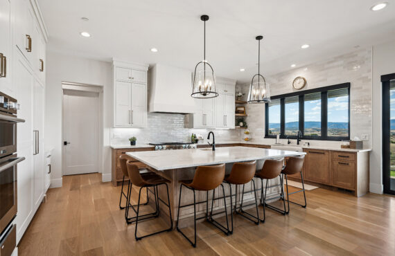 White painted and light brown stained kitchen with island.