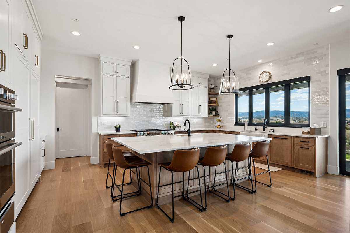 White painted and light brown stained kitchen with island.