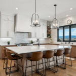 White painted and light brown stained kitchen with island.