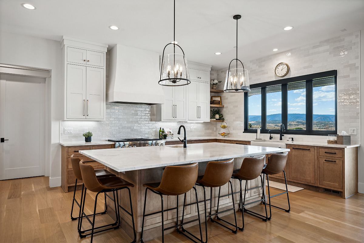 White painted and light brown stained kitchen with island.