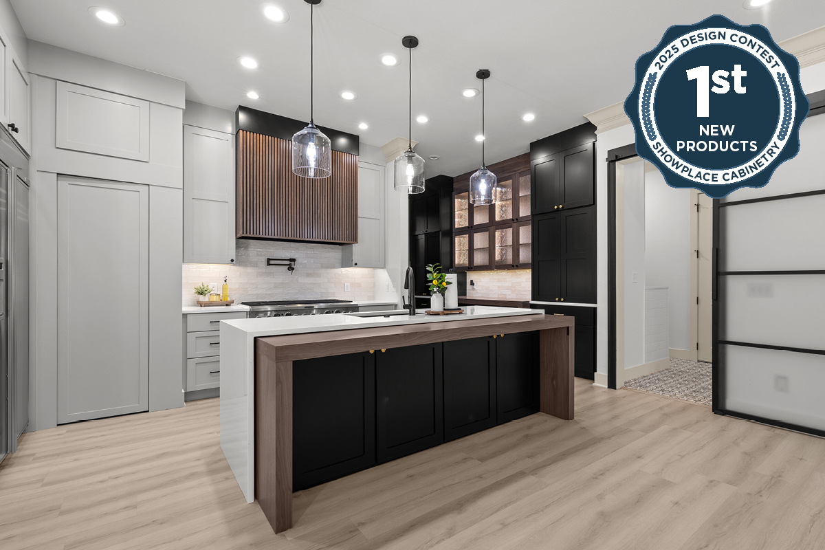 Light gray and black painted kitchen cabinets with walnut accent hutch cabinets, with a pullout walnut table connected to the island.