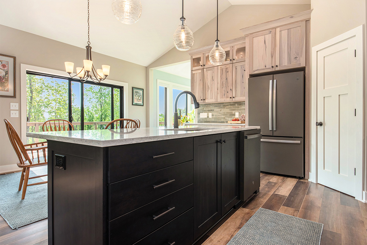 Light stain on perimeter kitchen cabinets and dark stain on island.