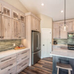 Light stain on perimeter kitchen cabinets and dark stain on island.