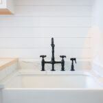 Painted white laundry/mud room with lockers.