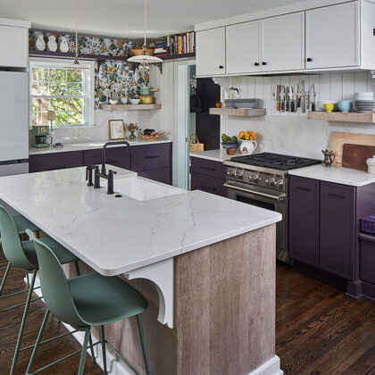 White and purple painted kitchen cabinets with stained hickory island cabinets.