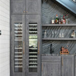 Dark stained hickory bar cabinets under a staircase